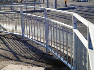 Pedestrian guardrail on the pavement next to the road.